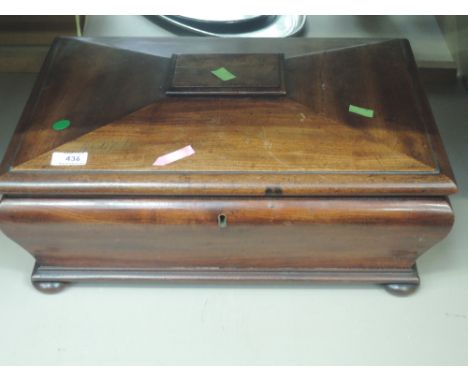 A mid Victorian mahogany tea caddy of large table top sarcophagus form having fitted interior and bun feet