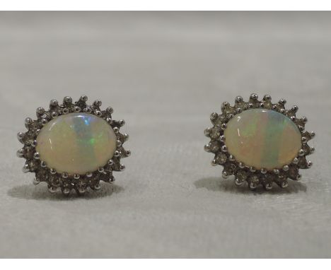 A pair of opal and diamond cluster stud earrings on 9ct gold mounts