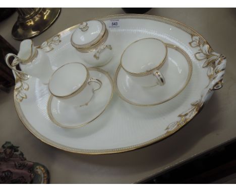 A Victorian part tea service having gilt heightened classical decoration on ribbed white ground