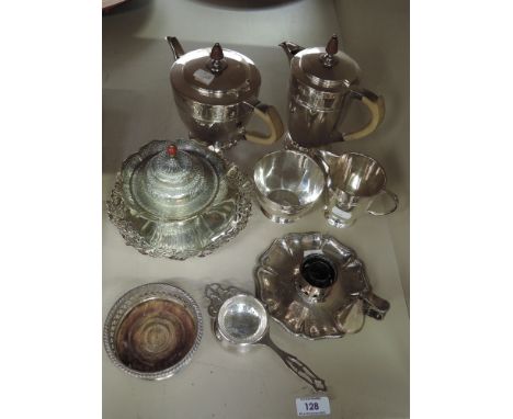 A small selection of silver plated ware including a four piece tea set, a Sheffield plate chamber stick and bottle coaster 