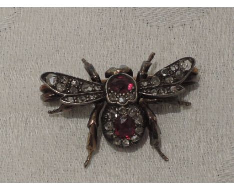 A Victorian bee brooch having ruby and diamond body, opal eyes and diamond set wings, mounted in yellow metal, no marksWING S