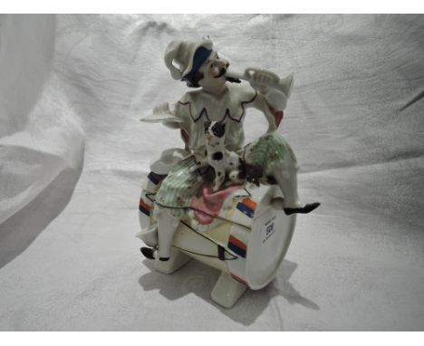 An early 20th century French design trinket pot modelled as musician with dog