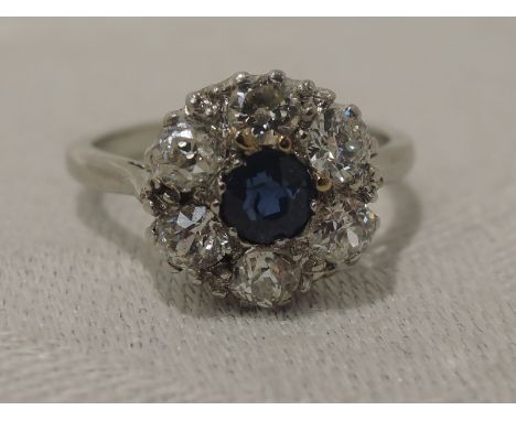 A lady's dress ring having a sapphire and diamond daisy cluster, approx 0.48ct &amp; 0.78ct in a claw set mount on a white me