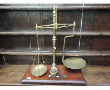 A set of late 19th/early 20th century brass weighing scales of traditional design on mahogany plinth, labelled Yorkshire Scal