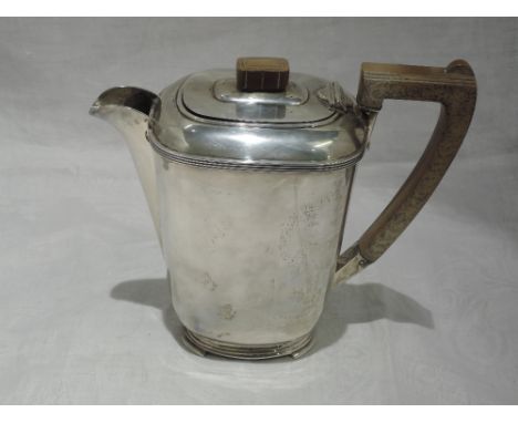 A silver coffee pot of plain form having fruitwood handle and knop with shaped pedestal foot, Sheffield 1936, Harrison Brothe