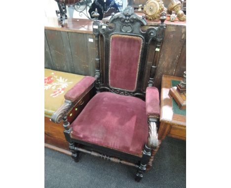 A late Victorian dark oak hall armchair having crest and finial back with 20th dralon upholstery on turned frame