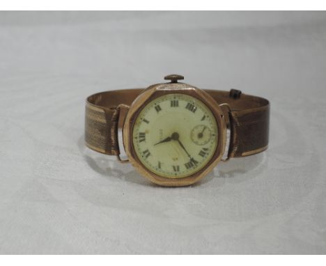 A 9ct gold gents vintage Rolco wrist watch having Roman numeral dial with subsidiary seconds in an octagonal case on rolled g