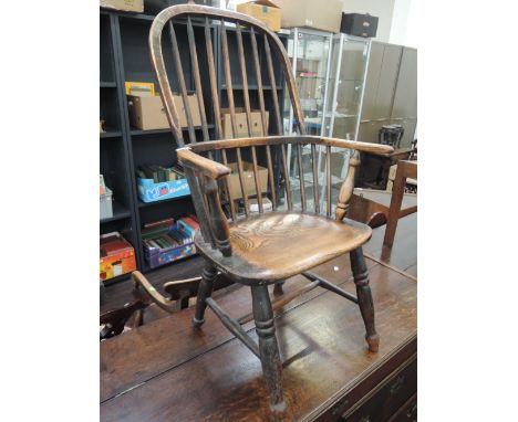 A 19th century beech and elm Windsor armchair having hoop and stick back with solid seat and turned legs