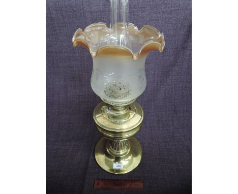 A 19th century brass frame oil lamp having later fluted shade