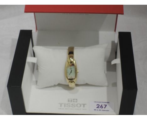 A lady's gold plated bangle watch by Tissot model 1853 having a baton numeral dial to mother of pearl face on a gold plated b