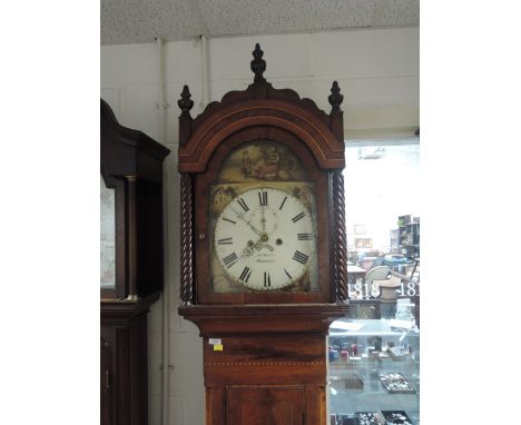 A late 18th/early 19th century mahogany longcase clock having crest spindle and arch hood containing painted face and 8 day m