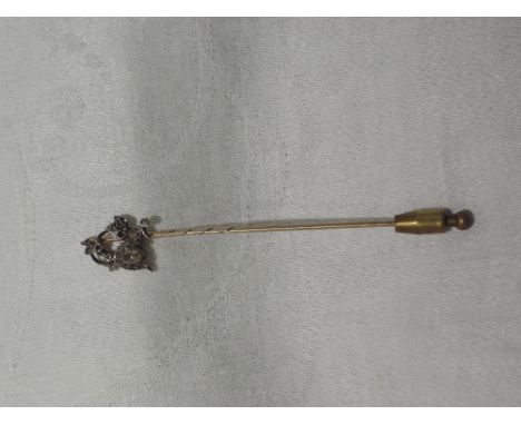 A yellow metal stick pin having  diamond set floral decoration