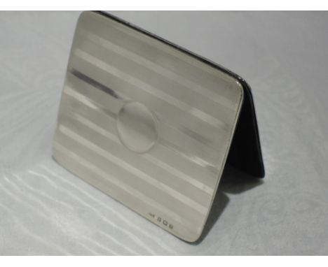 A silver mounted reversible note wallet having engine turned stripe decoration with plain cartouche, Birmingham 1916, A &amp;