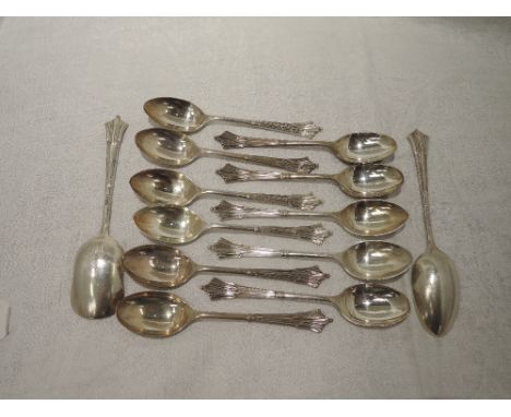 A set of eleven silver tea spoons and caddy spoon having moulded decoration to terminals and decoration to reverse of bowl, S