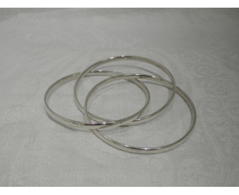 An HM silver triple slave bangle