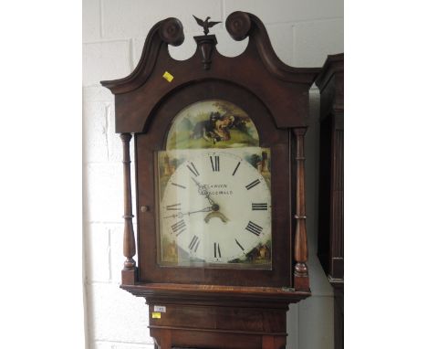 A late 18th/early 19th century mahogany longcase clock having swan neck and pillar hood containing arch painted dial and 30 h