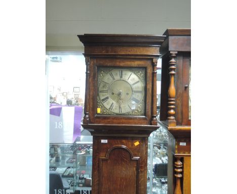 A late 18th century oak longcase clock having square and pillar hood containing brass spandrel square face with 8 day movemen