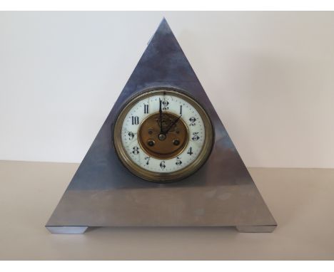 A triangular metal cased mantle clock, the white enamel chapter ring with Arabic numerals - enamel with various cracks - earl
