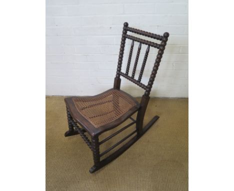 A 19th century beechwood bobbin turned rocking chair - Height 81cm x Width 40cm