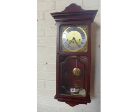 A modern Metamec 8 day wall clock in dark wooden case - working in sale room - Height 70cm