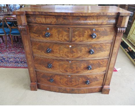 A Victorian mahogany bow front chest - frieze drawer over two short and three long graduated drawers - missing feet - flanked
