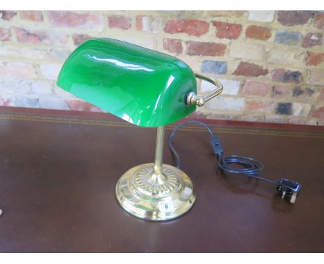 A modern desk lamp with green glass shade