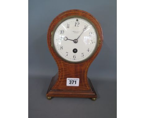 An Edwardian mahogany cased Liberty & Co balloon clock, white enamel dial marked Liberty & Co London with Arabic numerals