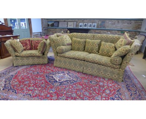 A large modern Knowle style sofa and matching smaller sofa both upholstered in a floral fabric with a range of loose cushions