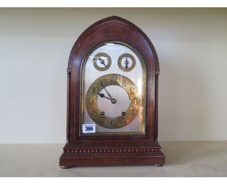 A 19th century Gothic style mahogany and line inlaid mantle clock with Arabic numerals to brass chapter ring, two subsidiary 