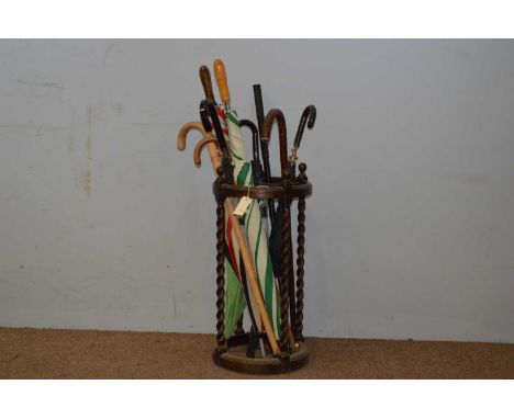 An Edwardian stick stand, the circular top with four divisions, raised on barley twist supports and circular plinth base cont