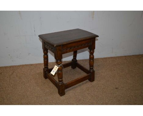 A 20th Century oak joint stool, in the 17th Century style, the shaped rectangular top raised on ring turned supports, the squ
