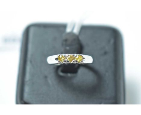 A three yellow stone ring, on 9ct white gold shank. 