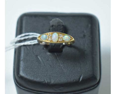 An early 20th Century opal and diamond ring, on 18ct yellow gold shank. 