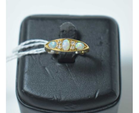 An early 20th Century opal and diamond ring, on 18ct yellow gold shank. 