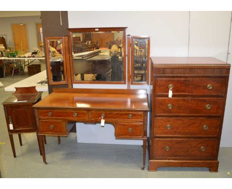 A four-piece mahogany bedroom suite, comprising: a dressing table with bevelled triptych mirror, above a rectangular top with