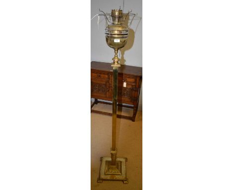 A late 19th/early 20th Century brass floor standing oil lamp, with pierced paraffin burner to the top, the square column with