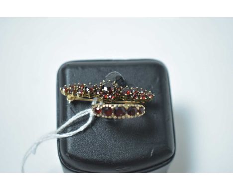 A five stone garnet ring, on 9ct gold shank; and a garnet set bar brooch, in yellow metal mount. 