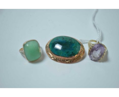 A turquoise coloured stone brooch, the oval cabochon within 9ct rose gold mount with leaf engraved design; an amethyst ring, 