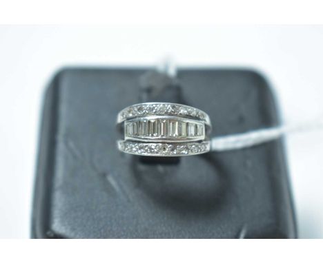 A vintage platinum and diamond half hoop eternity ring, the face being centrally bifurcated and pave set with diamonds, enclo