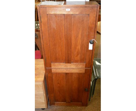 A late 19th / Early 20th century stained pine cupboard, the caddy top above a pair of paneled cupboard doors with turned horn