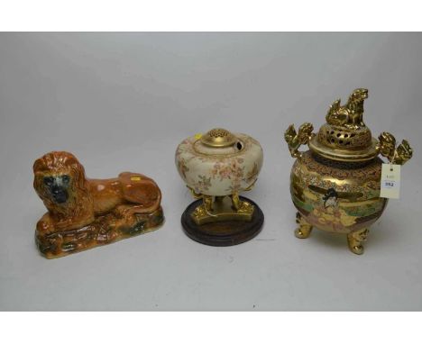 A Doulton Burslem floral decorated censer, the body decorated with pink flowers on three dolphin supports joined by a shaped 