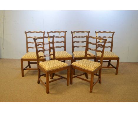 A set of six 19th Century mahogany ladderback dining chairs, the undulating top rails above pierced ladder supports, the drop