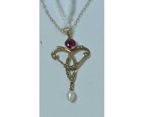 An Edwardian pendant, set with ruby and seed pearls, on a fine link chain. 