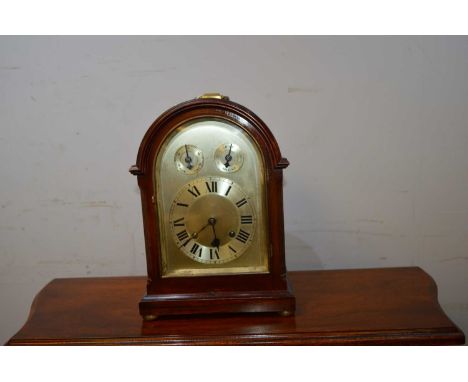 A 20th Century mahogany framed mantel clock, the 6 1/2in. silvered dial with arabic hours and subsidiary chime silent dial, s