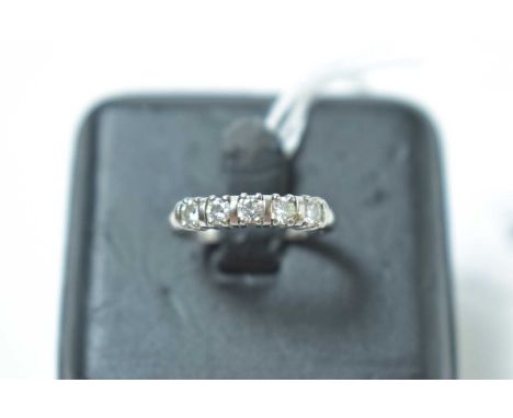 A contemporary 18ct white gold and five stone diamond ring, each round cut brilliant being interspersed with a spacer, 3.2g