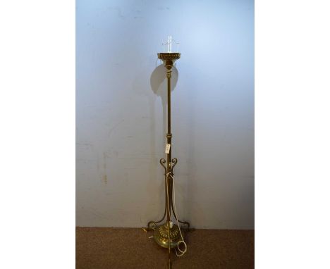 A 20th Century brass standard lamp, the circular top raised on a brass column with scrolled upright gadrooned circular base, 