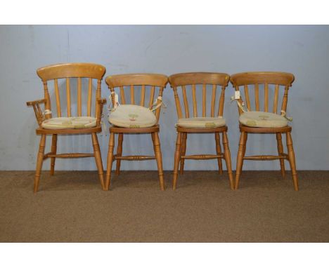 A set of four 20th Century beech kitchen chairs, including one carver, each with yoke-shaped top rails, spar supports above s