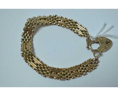 Yellow metal gate link bracelet, the heart shaped locket stamped 'WHW Ld 9ct', 18.4g. 