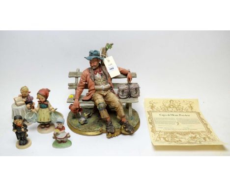 A certificated Capodimonte figure 'Hotel Splendide', modelled by Volta, approximately 25cms wide; together with four Hummel f