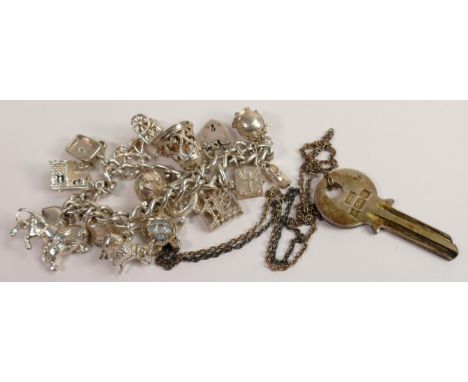 Sterling silver charm bracelet with 15 silver charms together with 1977 hallmarked silver key pendant &amp; chain, gross weig